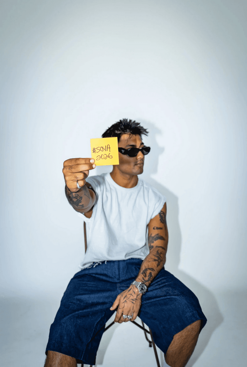 Person holding #SOYA2026 sticky note